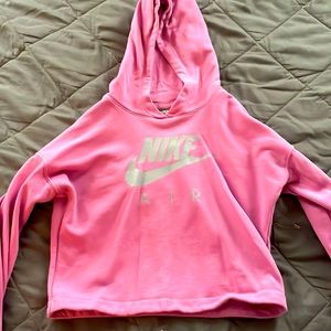 A pink Nike cropped hoodie